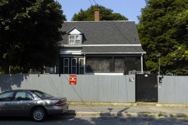 The Outlaws motorcycle gang’s clubhouse at 9 Hunt St. in Brockton is protected by guard dogs, padlocks on the doors and camears located on the fence. This photo was taken in August 2007.