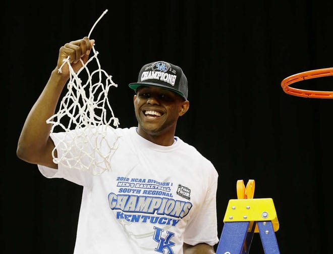 Kentucky senior Darius Miller holds the net after cutting it down after the NCAA South Regional finals against Baylor on Sunday.