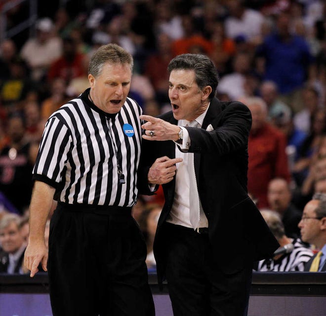 Louisville head coach Rick Pitino argues a call during the NCAA regional final against Florida on Saturday. He's in the Final Four - back on top of the basketball world three years after a sordid extortion case.