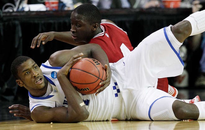 Kentucky's Michael Kidd-Gilchrist, front, battles for a lose ball with Indiana's Victor Oladipo during an NCAA tournament game on March 23.