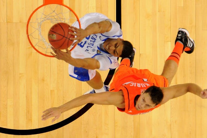 Kentucky's Anthony Davis dunks against Louisville's Kyle Kuric tonight during the opening game in the Superdome.