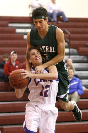 Central’s Scott Farey comes down on Lake’s Josh Duerr. The South boys came away with a 105-89 win Friday.