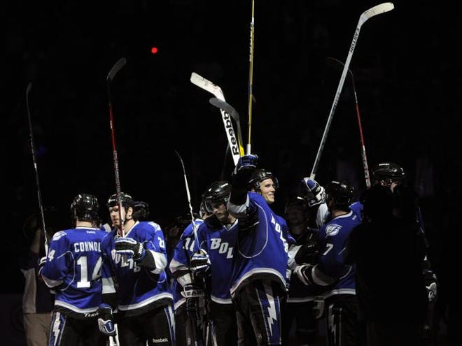 The Tampa Bay Lightning celebrate center Steven Stamkos' overtime goal in their 3-2 win over the Winnipeg Jets on Saturday, March 31, 2012, in Tampa.