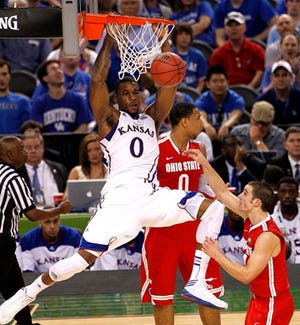 Kansas forward Thomas Robinson slam dunks over Ohio State forward Jared Sullinger (0) and guard Aaron Craft (4) during Saturday's NCAA Final Four game in New Orleans.