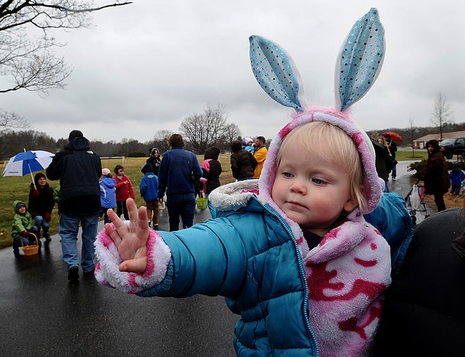 Kayleigh Scott, 1, of Natick, waves to the Easter Bunny while being held by her mother Heather Rudenauer during the second annual Easter Egg Hunt, sponsored by the Framingham Parks and Recreation Department.