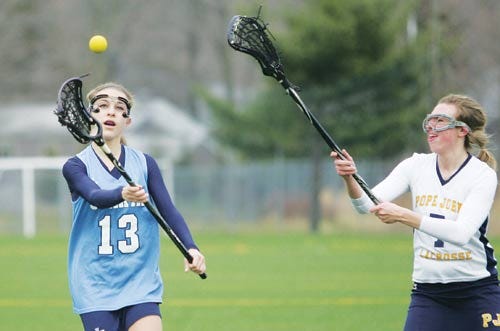 File Photo by Daniel Freel/New Jersey Herald - Sparta’s Emily Corrice, left, shoots the ball as Pope John’s Cat Carola defends during a lacrosse game last season. Corrice, a junior, is expected to be one of Sparta’s top players this season.