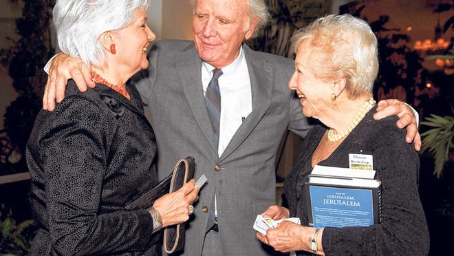 James Carroll talks with Nicole Hynes, left, and Hope Cramer at the Palm Beach Fellowship of Christians and Jews annual dinner.