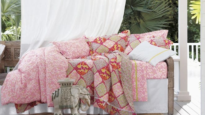 The quilt, coverlet, sheets and shams in the Sweet Pea collection are decorated with images of blossoms in a variety of styles and sizes.