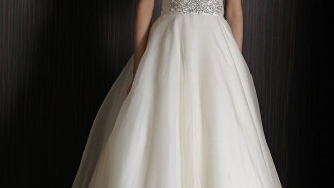 Keeneland strapless organza gown with shirred bodice, beaded belt and full ball skirt is among the spring offerings from the Badgley Mischka bridal collection.