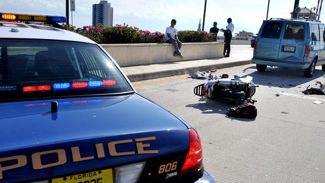 081610 PBDN Jeffrey Langlois 1 of 1 The westbound lane of Royal Palm Way over the Royal Park Bridge is closed after a man riding a scooter rear-ended a Chevrolet van Monday afternoon.