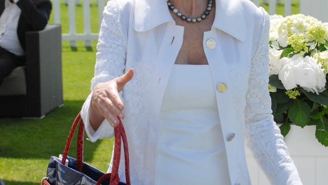 In July, designer Lana Marks, shown here at the Cartier Polo matches in Surrey, was in England to launch her collection at London’s Harvey Nichols store, creating the special-edition $25,000 Union Jack Positano tote she carries. Marks has closed her Worth Avenue boutique, but intends to reopen in a new location during the season.