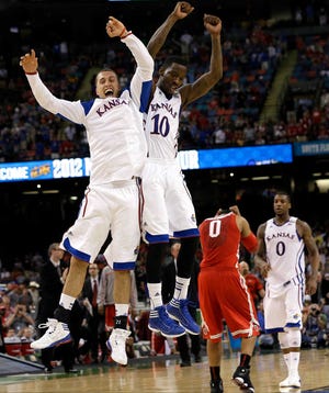 Kansas guard Tyshawn Taylor (10) celebrates with Kansas guard Christian Garrett at the end of an NCAA Final Four semifinal college basketball tournament game against Ohio State Saturday, March 31, 2012, in New Orleans. Kansas won 64-62. (AP Photo/David J. Phillip)