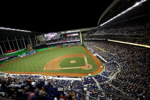 Fans at the new Marlins Park watch a spring training baseball game between the Miami Marlins and the New York Yankees, Monday, April 2, 2012, in Miami.