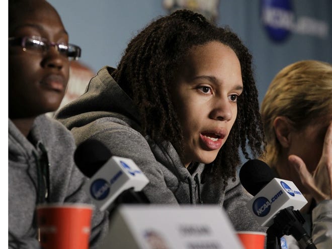 Flanked by Kimetria Hayden, left, and coach Kim Mulkey, Baylor's Brittney Griner, center, answers questions for the media during a news conference, Monday, April 2, 2012, in Denver. Baylor will play Notre Dame for the women's NCAA championship basketball game on Tuesday.