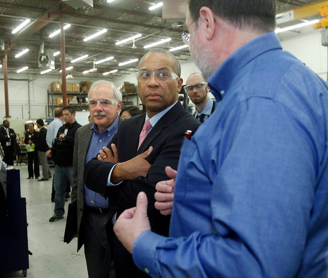 Gov. Deval Patrick, middle, listens to President and Founder Franklin Jones during a tour of Comprehensive Power Co. in Marlborough yesterday. Company CEO Charles Cuneo, rear, listens.