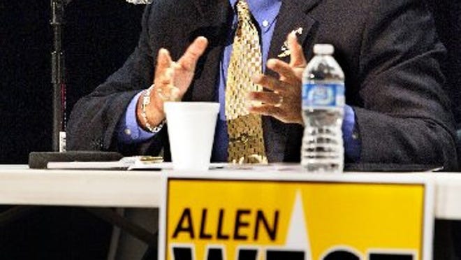 Allen West talks with a group of people at Century Village Wednesday April 4, 2012.