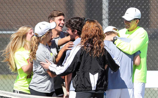 Members of the Lubbock High tennis team celebrate after the boys doubles title match during the District 2-5A tournament on Thursday at the Burgess-Rushing Tennis Center. Westerners captured district championships in four of the five events.
