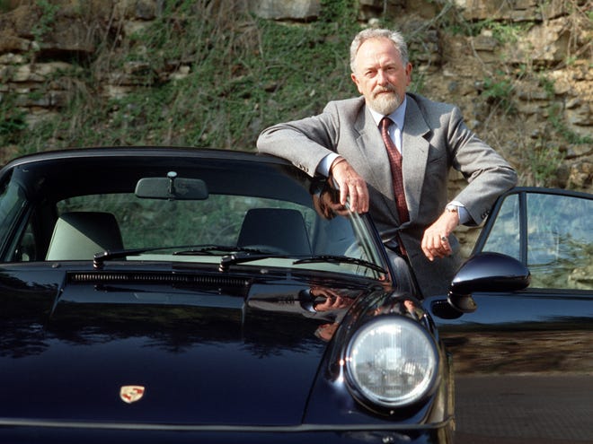 In this publicly released undated file photo provided by Porsche AG, Car designer Ferdinand Alexander Porsche is photographed at unknown location with a Porsche 911 Carrera. Ferdinand Alexander Porsche, the design chief credited with the classic 911 sports car and grandson of the automaker's founder, has died. Carmaker Porsche AG said Porsche was 76 and died Thursday in Salzburg, Austria. (AP Photo/Porsche AG)