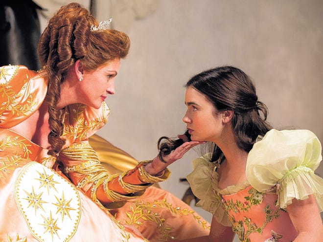 In this image released by Universal Pictures, Julia Roberts portrays the evil queen, left, and Lily Collins portrays Snow White in a scene from Relativity Media's "Mirror Mirror."