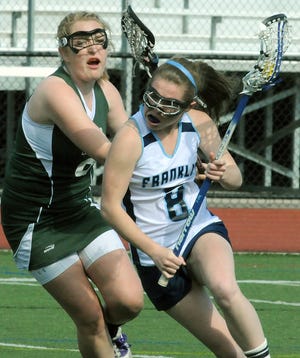 Franklin's Bridget Doherty gets around Mansfield's Kristin Teljuda during the Panthers' 12-0 win yesterday. Daily News photo by John Thornton