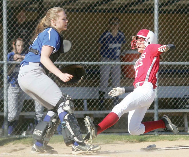 Kittatinny catcher Abbey Miller awaits the throw home as Morris Hills' Ashley Ferrante scores during the third inning of Thursday's non-league matchup in Hampton.