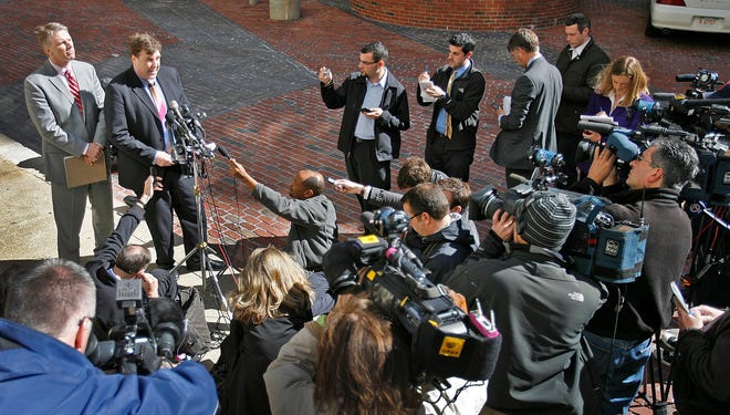 Former State Treasurer Tim Cahill at Suffolk Superior Court in Boston on Wednesday April 4, 2012, to answer charges of political corruption for advertisements by the Mass. Lottery during the 2010 governors campaign. Cahill, at left, and his lawyer E. Peter Parker face the media after Cahill's arraignment.