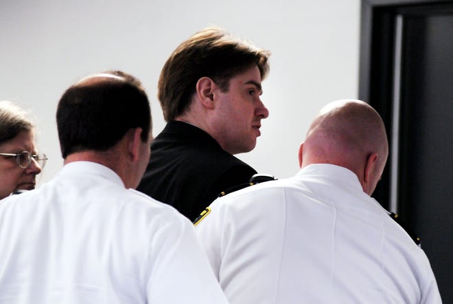 Neil Entwistle looks over at his parents as court officers escort him out of Middlesex Superior Court after Judge Diane Kottmyer sentenced him to life in prison with no chance of parole for the murder of his wife and baby. 
6/26/08