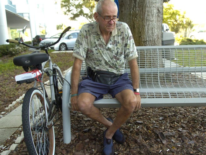 Chuck Sanders sits next to his bicycle Friday morning April 6, 2012 in Sarasota. Last week, Sanders has lost his wallet containing $360 he needs to make rent. Today, his wallet was returned via the mail by a Good Samaritan, complete with all his money.   (Apr. 6, 2012; Herald-Tribune staff photo by Mike Lang)