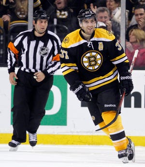 Patrice Bergeron skates toward the bench after scoring in a shootout against the Sabres on Saturday. The Bruins won, 4-3.