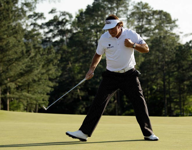 Phil Mickelson pumps his fist after a birdie putt on the 18th green during Saturday's third round of the Masters in Augusta, Ga.