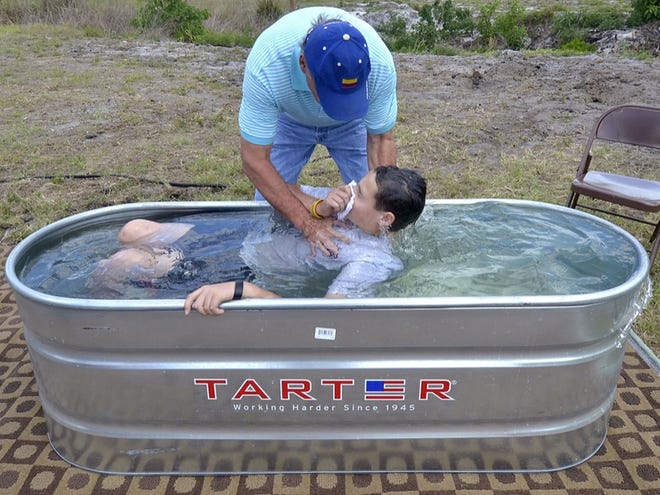 Pastor Ron Bos baptizes Jake Williams, 15, on Saturday during a public baptism in Winter Haven. Saturday April 07, 2012.