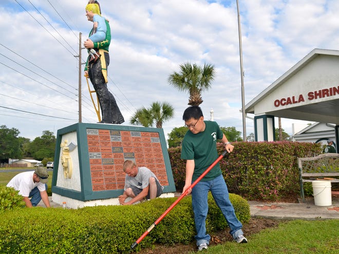 Eagle Scout candidate Chris Standish rakes out old mulch from under shrubs March 24 at the Ocala Shrine Club. Standish took on the task to improve the grounds for his Eagle project along with the help of fellow scouts and volunteers.