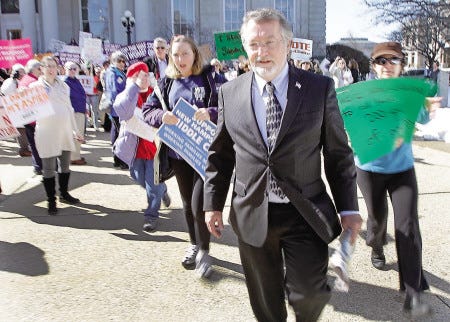 New Hampshire Republican House Speaker William O'Brien is heckled as he leaves the statehouse after the Republican-controlled House voted to allow employers with religious objections to exclude contraceptive coverage from their health plans.