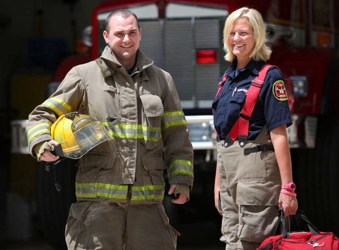 St. Johns County firefighter of the year Andrew Kirkland stands with St. Johns County paramedic of the year Jenny Butler outside of Station 14 on Thursday, April 5, 2012. BY DARON DEAN, daron.dean@staugustine.com