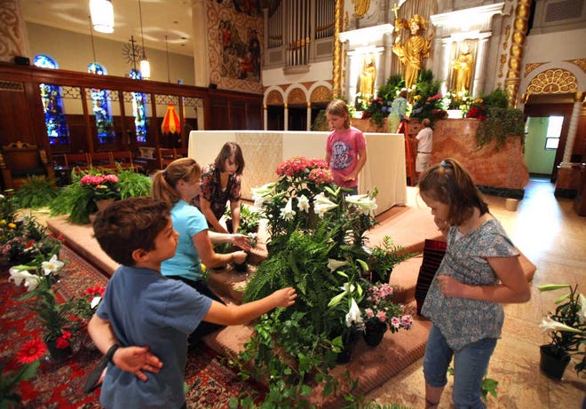 From left, Joseph Garofalo, 7, Carole Gauronskas, Elisabetta Schiavo, 14, Sara Schiavo, 8, and Elena Schiavo,10, decorate the alter at the Cathedral Basilica of St. Augustine with flowers and foliage in preparation for their Easter Vigil on Saturday, April 7, 2012. BY DARON DEAN, daron.dean@staugustine.com