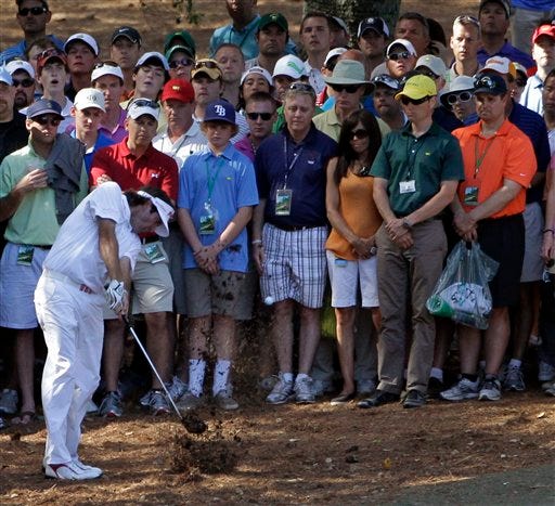 AP Photo/Darron Cummings - Bubba Watson hits out of the rough off the 10th hole during the fourth round of the Masters golf tournament Sunday, April 8, 2012, in Augusta, Ga.
