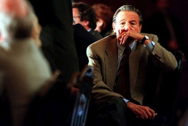 Mike Wallace listens to speakers during a 1999 conference about covering assisted death at the University of Michigan in Ann Arbor. Wallace, who graduated from the University of Michigan in 1939, died Saturday at age 93.