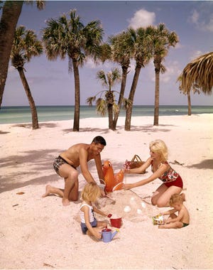 In this undated photo by Joseph Janney Steinmetz, a family builds a sand castle on a Sarasota beach. ( Photo by Joseph Janney Steinmetz / State Archives of Florida)