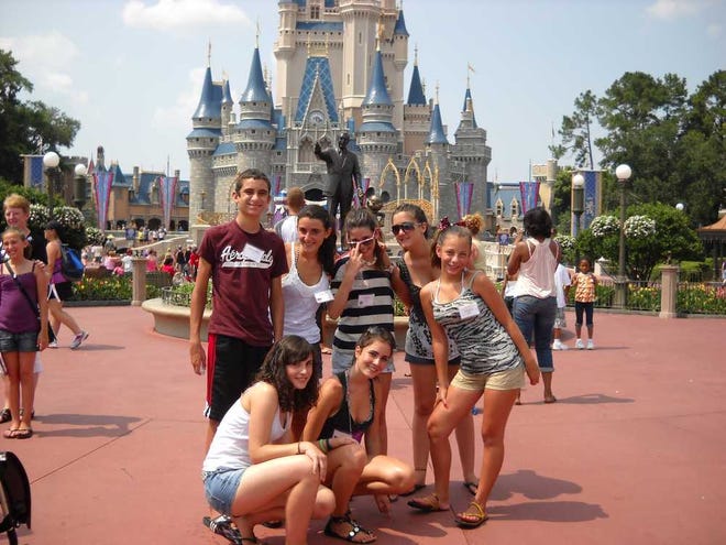 Host families are needed for Spanish students coming here in July. This photo shows a group from last year posing for a group shot during a visit to Disney World. Contributed photo.