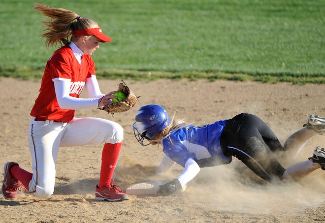 Morton's Kelsi Dahms, left, watches as Sheyanne Redmon of Limestone slides into second base safely during Tuesday's girls softball game at Limestone High School.