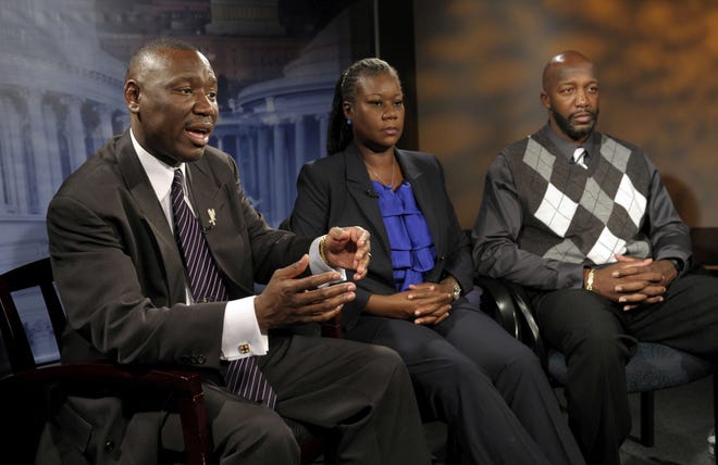 Attorney Ben Crump (left), and Trayvon Martin's parents, Sybrina Fulton and Tracy Martin, talk with Associated Press reporters Wednesday, April 11, 2012, in Washington. After weeks of mounting tension and protests across the U.S., a special prosecutor has decided to bring charges against neighborhood watch volunteer George Zimmerman in the killing of the unarmed 17-year-old.