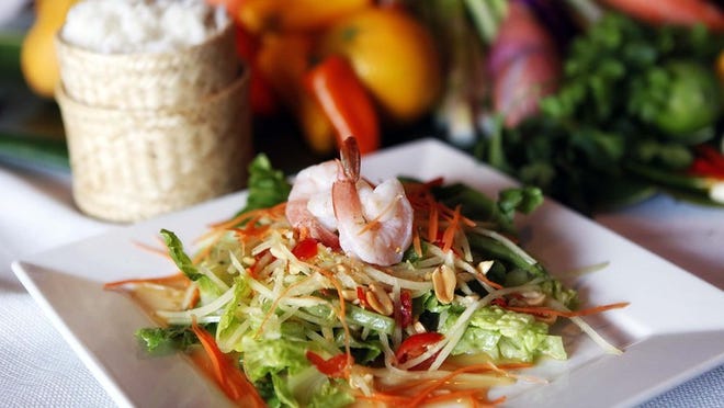 The Thai papaya salad served with sticky rice is a signature dish at Malakor Thai Cafe in the Northwood district of West Palm Beach. (Bruce R. Bennett/The Palm Beach Post)