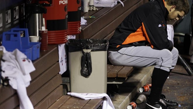 Josh Johnson sits on the bench after being pulled in the fourth inning of a 7-1 loss to the Phillies on Wednesday night.