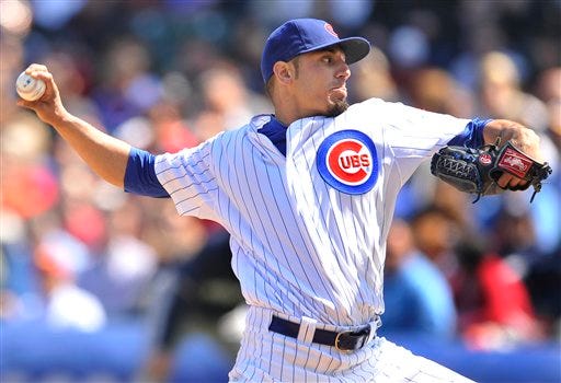 Chicago Cubs starter Matt Garza delivers a pitch against the Milwaukee Brewers during the first inning of a baseball game in Chicago, Thursday, April 12, 2012. (AP Photo/Paul Beaty)