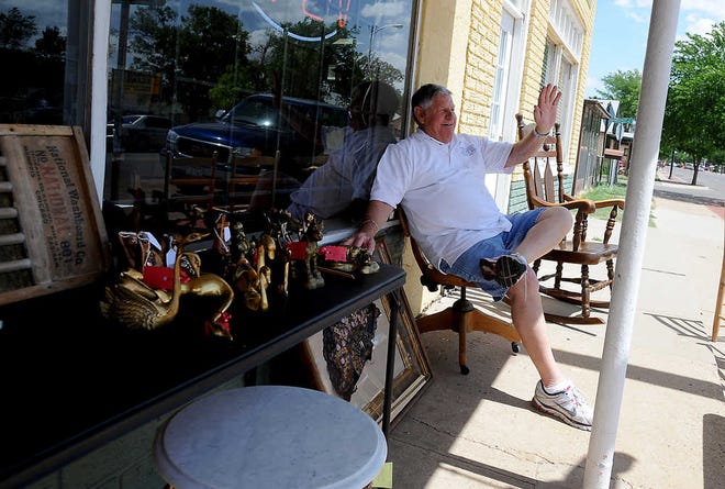 Michael Norris / Amarillo Globe-News Enjoying the nice day Billy Benton waves to cars as they pass by while he sets outside of 6th Street Collectables Saturday, April 14, 2012.