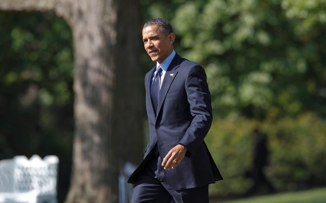 President Barack Obama walks to his helicopter Friday at the White House on 
his way to Andrews Air Force Base.
ASSOCIATED PRESS / J. SCOTT APPLEWHITE