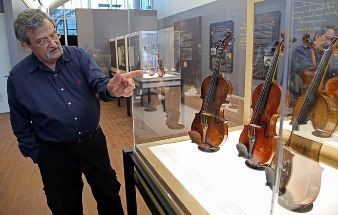 Standing next to a display, violin maker Amnon Weinstein talks last week 
about the stories behind the Violins of Hope exhibit at the University of 
North Carolina.ASSOCIATED PRESS PHOTOS / CHUCK BURTON