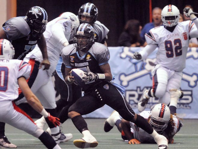 The Lakeland Raiders' Tavares Woodley (#2) scrambles for yardage during their game against the Florida Tarpons at The Lakeland Center.