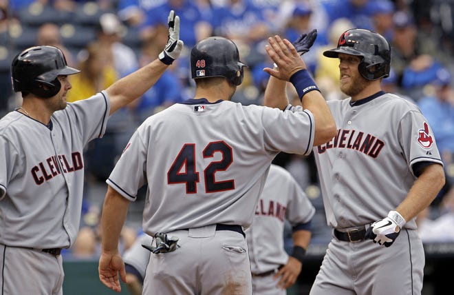 Cleveland Indians' Shelley Duncan (right) celebrates with Travis Hafner (center) and Casey Kotchman after hitting a three-run home run during the third inning of Sunday's game against the Kansas City Royals in Kansas City, Mo.