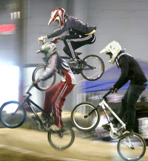 Racers catch some air at Indoor BMX Saturday.